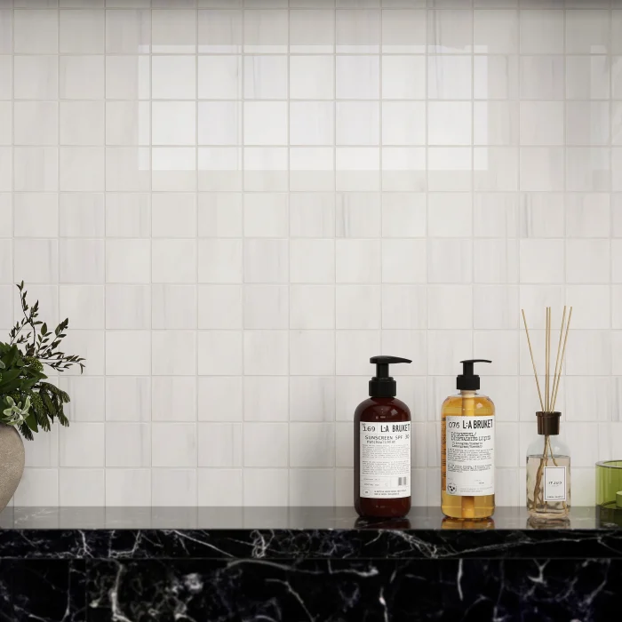 Close-up of Bianco Dolomite polished square marble mosaic in a shower niche