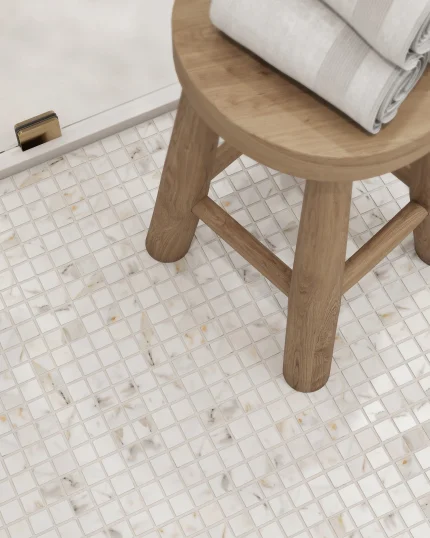 Close-up of Calacatta Gold honed marble mosaic on a bathroom floor showing veining detail