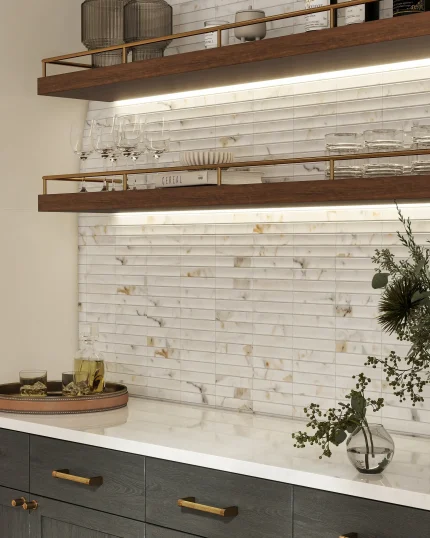 Close-up of Fluted Calacatta 3D marble mosaic showing bold gold and grey veining across carved fluted profile