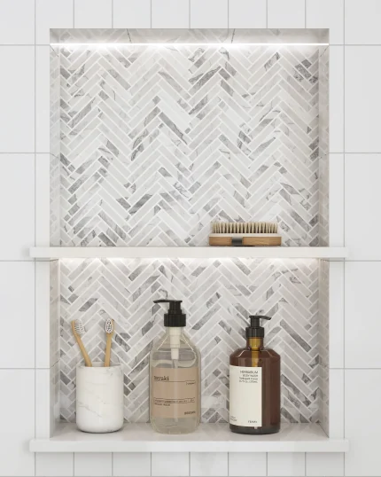 Italian Statuary polished mini herringbone marble mosaic tile installed in a shower niche