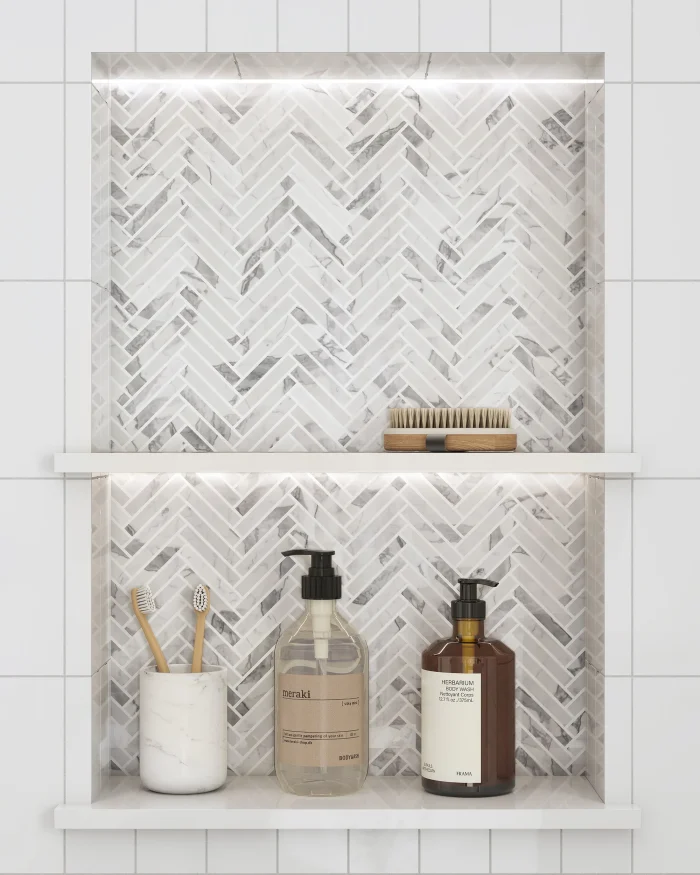 Italian Statuary polished mini herringbone marble mosaic tile installed in a shower niche