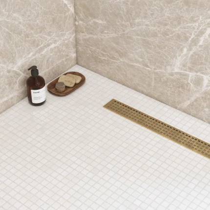 Thassos 1x1 square polished marble mosaic tile installed on a shower floor
